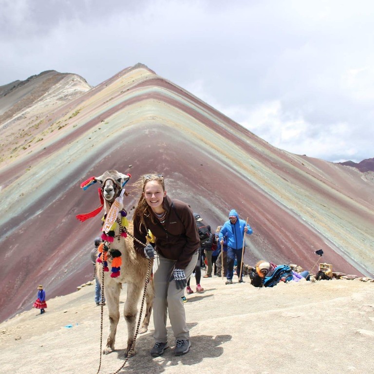 HIEP recipients in South America - Brianna Mahnke with an alpaca on beautiful dunes in Lima Peru