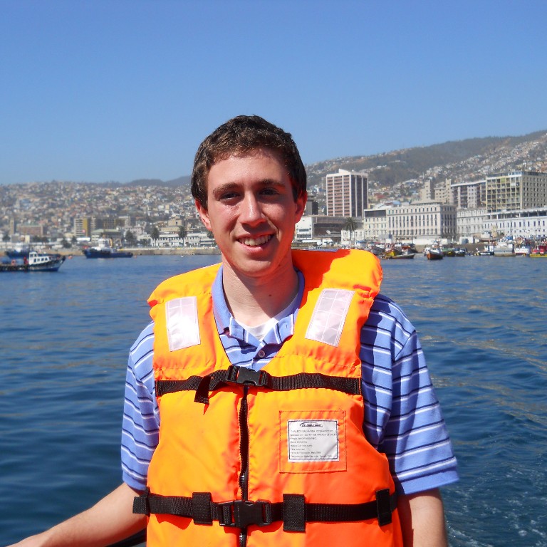 HIEP recipients in South America - Jonathan Moberly in a life jacket poses for a picture from a boat in the Valparaiso harbor