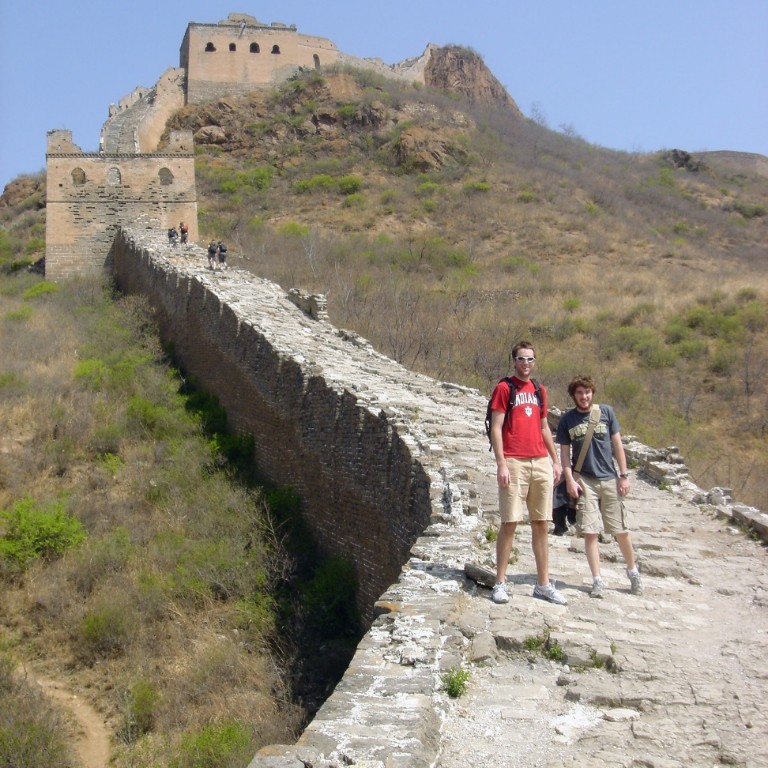 Students posing for the camera while hiking on the Great Wall of China