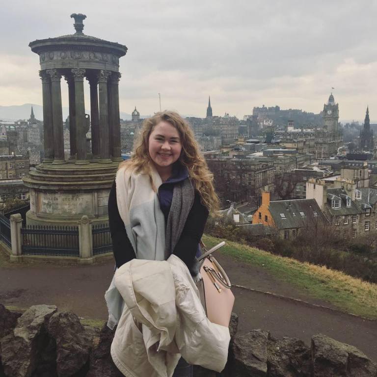 HIEP students in the UK - Julia Bourkland poses for a photo overlooking Edinburgh Scotland.