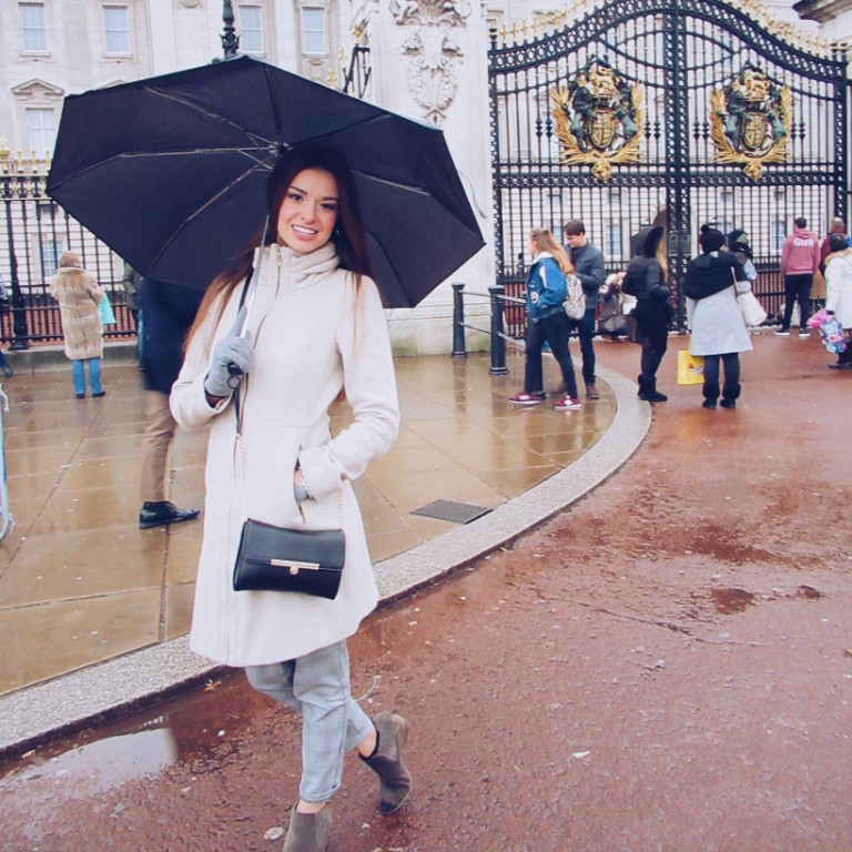 HIEP students in the UK - Julia Klinestiver poses with an umbrella in front of Buckingham Palace in London