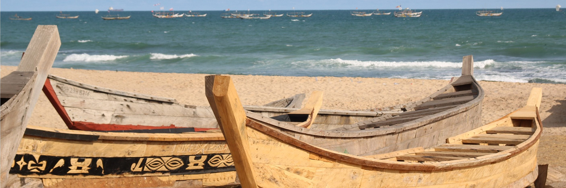 Wooden boats on a beach along the coast of Ghana