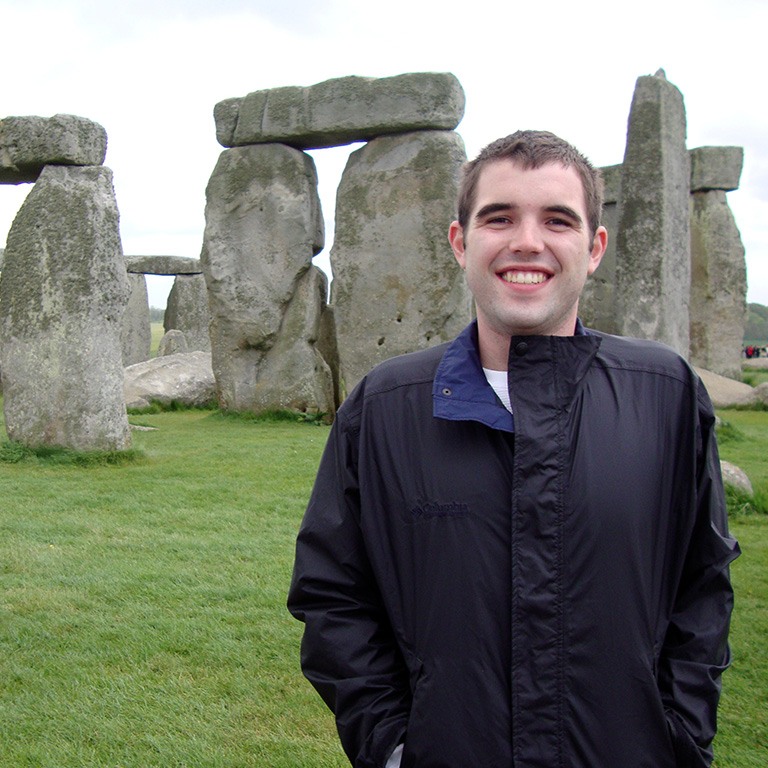 Student posing in front of Stonehenge